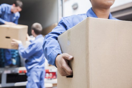 Professional movers assisting with a house removal in West London