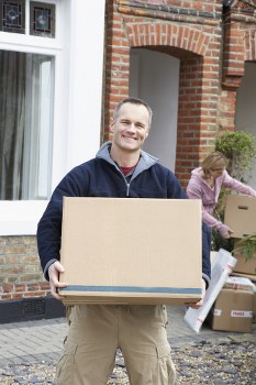 Family unpacking boxes in their new Reigate home