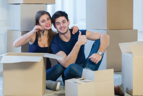 Moving truck loaded with furniture and boxes outside a home