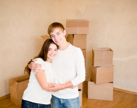 Family packing household items into boxes for moving